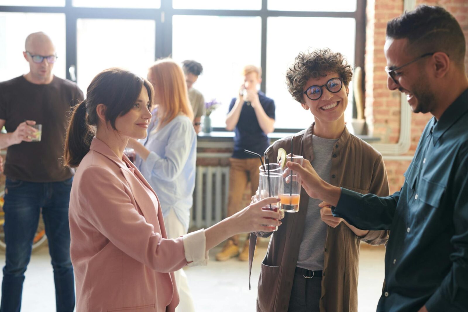 photo of people holding glasses