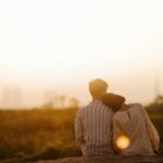 man and woman near grass field